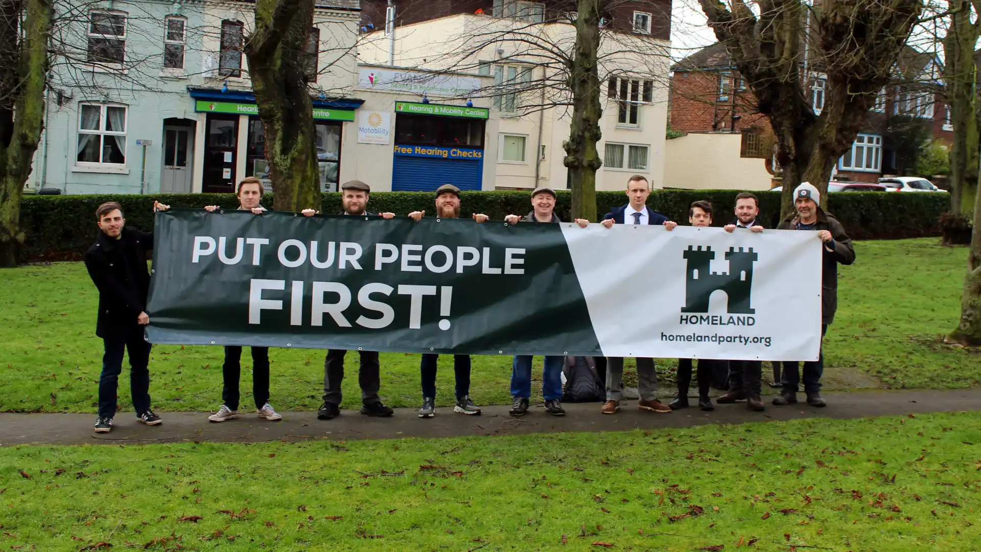 Homeland Party activists with 'Put Our People First!' banner